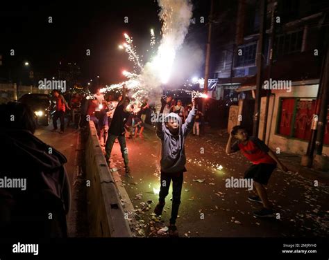Indonesian youths light firecrackers and flares as they celebrate the ...