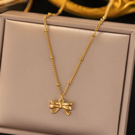 Jewels Galaxy Gold Plated Stainless Steel Anti Tarnish Bow Themed Pendant