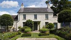 royal cottage residence the exterior of llwynywermod a white washed cottage set royal cottage residence the exterior of llwynywermod a white washed cottage set