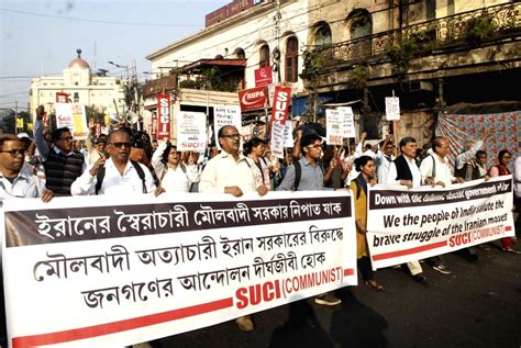 SUCI activists hold placards as they shout slogans during a protest