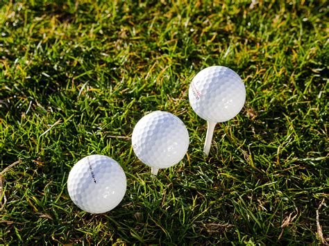 Download 4k Three Golf Balls Wallpaper | Wallpapers.com
