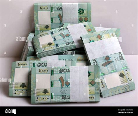 Stacks of Lebanese pounds, 100,000 denomination, symbolizing the downfall of the Lebanese ... - currency of lebanon