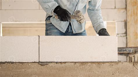 Construction workers are making white lightweight concrete blocks that ...