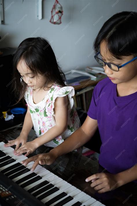 Premium Photo | Happy kids playing piano at home