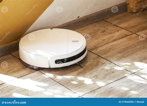Robot Vacuum Cleaner Cleans the Tiled Floor in the Living Room Near the ...