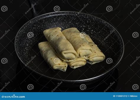 Pancakes Stuffed in a Frying Pan on an Induction Cooker Stock Photo ...