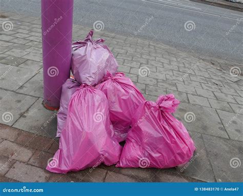 Stuffed Pink Garbage Bags on the Roadside are Ready To Pick Up Stock ...