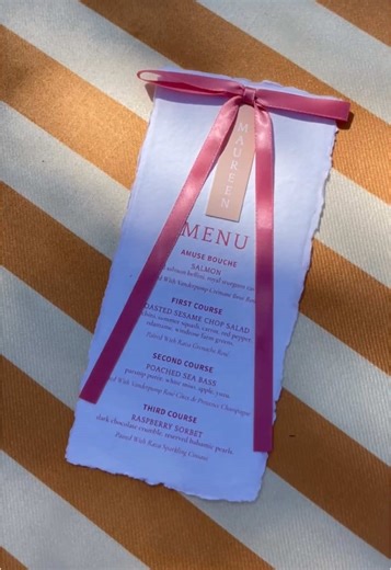 Day 24: Women in Wine Rosé, styled. Custom creamsicle place cards on handmade deckle paper layered with a dramatic rosé bow moment, set against Avenue Twelve’s Sofia Yellow Stripe Scalloped Sofa and elevated by an eight-by-eight rose floral mural. Design details, intentionally paired for Vanderpump and Rava Rosé. Venue: @Rava Wines Weddings @ravalauren Host: @lisavanderpump @vanderpumprules Rosé: @vanderpumpwines @Rava Wines Chef: @pair_with_chef_rachel Design & Rentals: @Avenue | Twelve Events 