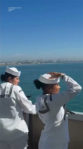 USS Abraham Lincoln sailors line up as San Diego comes into sight