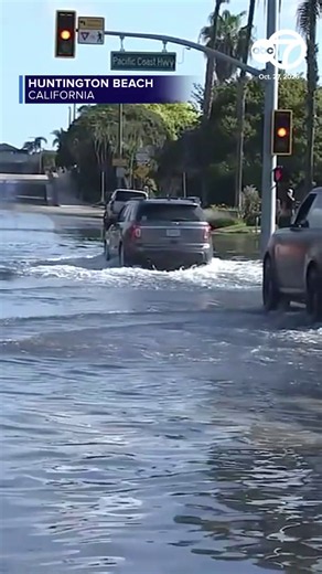 A stretch of Pacific Coast Highway in Huntington Beach was flooded with several inches of sea water following high tide Tuesday morning.