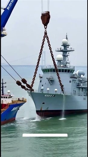 The crane malfunctioned while lifting the warship.#container #ocean
