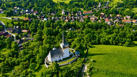 A medieval church surrounded by the quiet hills of Transylvania
