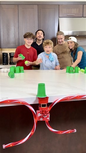 Who will win the Holiday Sliding Cup Game 🎄 Our family slides party cups with tennis balls in them to land in Santa's cup for the hidden prizes. #games #partygames #Christmas #christmasgames #HolidayGames | The Tus House
