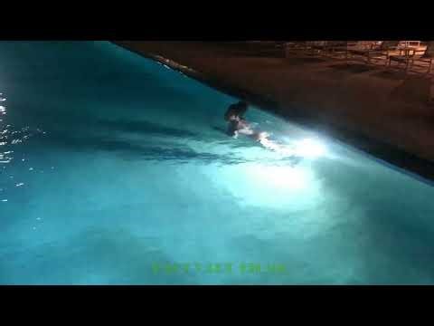 Beautiful lady night swimming in pool