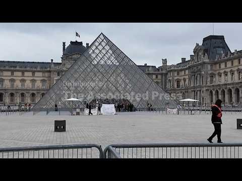 Students block entrance to Louvre in Paris, preventing it from opening