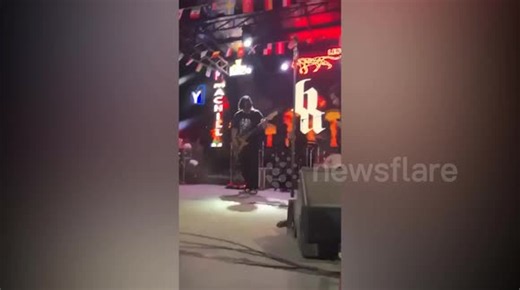 Singer falls through stage mid-concert but returns to finish show
