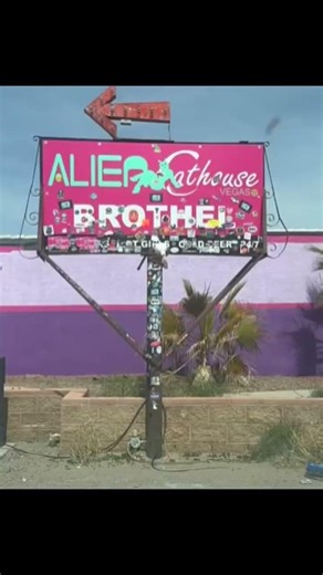 Alien Brothel in Nevada, putting my sticker on the sign