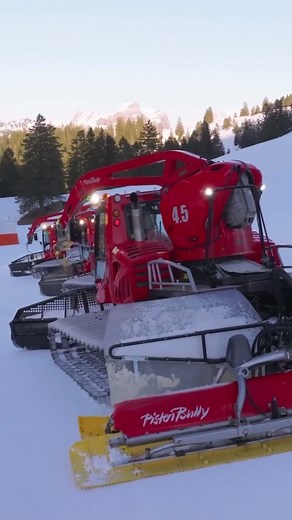 Extreme snow groomers and snowmaking machines working together to build perfect ski slopes.