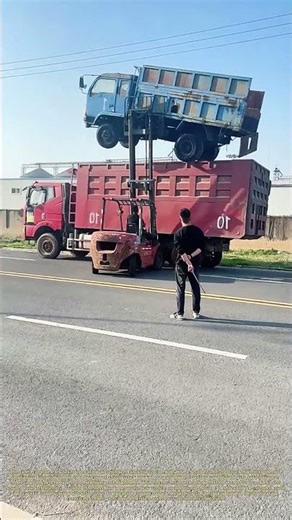 Lifting a Small Truck: How a Forklift Loads a Mini Dump Truck Onto a Larger Hauler