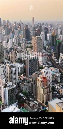 Bangkok, Thailand - June, 6, 2025: Aerial drone view of Bangkok skyline at sunset with modern high rise buildings and golden evening light. Vertical Stock Video Footage - Alamy