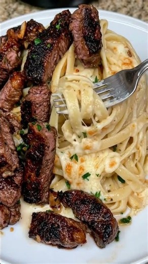 Steakhouse Garlic Butter Beef Tips over Cheesy Parmesan Fettuccine