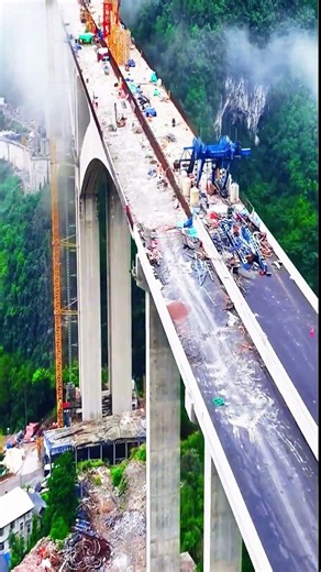Incredible infrastructure building a bridge over rugged valley