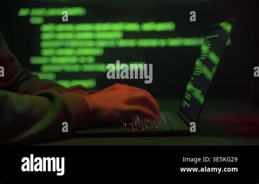 Close-up of anonymous hacker hands typing on laptop with glowing green code lines moving on background. Cybercrime, hacking activity, cybersecurity threats, and digital intrusion Stock Video Footage - Alamy
