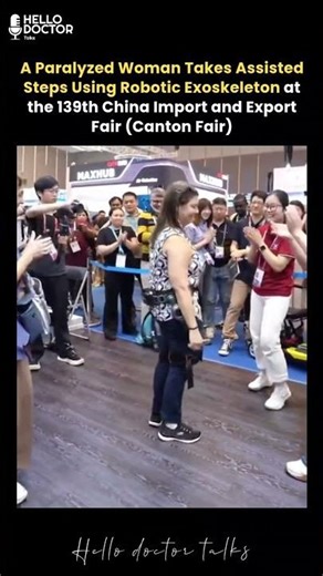 A paralysed woman takes assisted steps with robotic exoskeleton