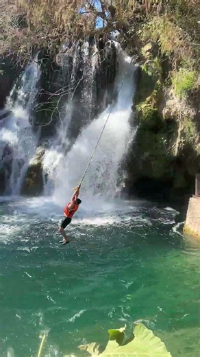 Man Swings Over Waterfall and Plunges In