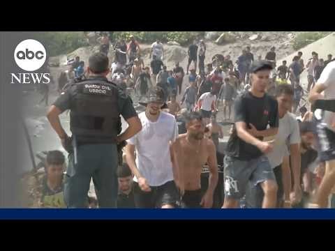 Thousands of migrants surge into Spanish enclave in North Africa