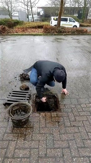 S#058-2 Unclogging a storm drain during rain in Germany, #shorts