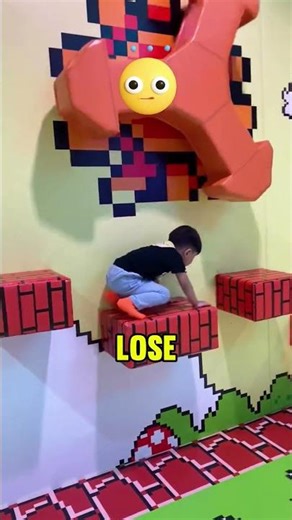 The boy is in the Super Mario obstacle course! 🏃‍♂️🎮