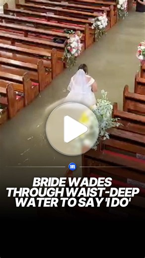 A couple in the Philippines refused to postpone their wedding despite severe flooding, going ahead with the ceremony as water filled their church. Bride Liean Liza Chico carefully made her way through the murky water in her wedding gown, with groom Gilbert Chico waiting for her at the altar as family and friends looked on. 🎥 Newsflare #wedding #flood #news #viral #philippines