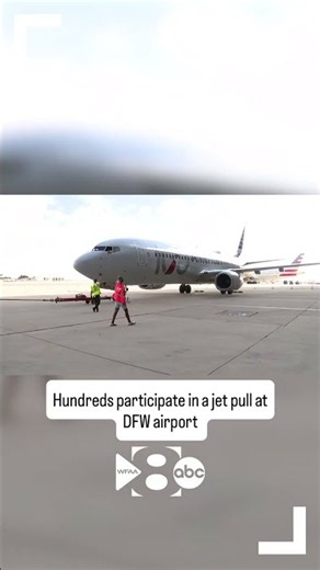 Hundreds participate in a jet pull at DFW airport, proving that many hands make light work.