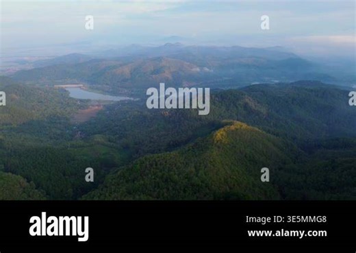Aerial drone view of the top of a row of hills and mountains with forests and trees in the morning in Banyumas, Central Java, Indonesia Stock Video Footage - Alamy