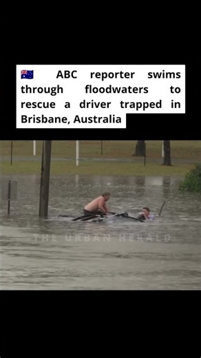 ABC reporter swims through floodwaters to rescue a driver trapped in Brisbane, Australia