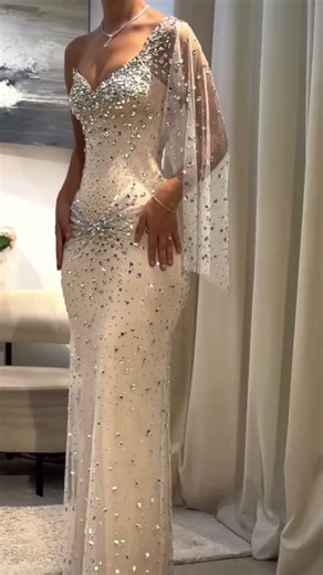 Share with a friend who would own the spotlight in this champagne column corset gown! To order, send