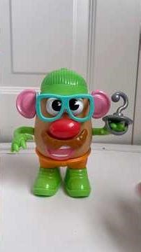 Taking Mr.Potato Head apart with green head and mustaches