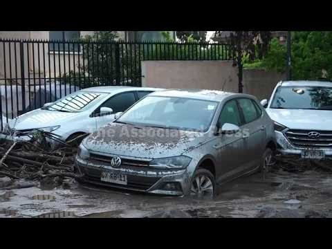 Chilean forces respond to flooding after heavy rain sweeps away cars and inundates homes