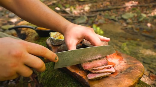 Watch how garlic butter steak and potatoes come together over fire