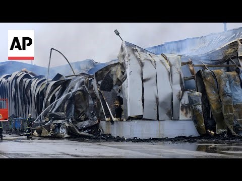 Firefighters battle flames after deadly explosion at cookie factory in Greece