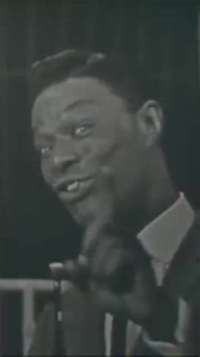 Nat King Cole’s unmistakable voice singing “Quizás, Quizás, Quizás” en Español.