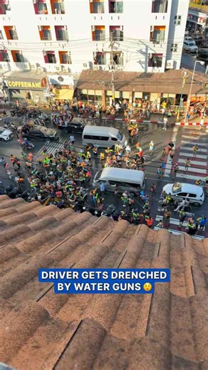 Driver reacts after being soaked during Songkran festival in Phuket