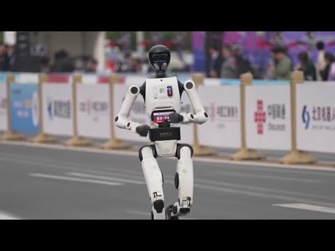 Humanoid robots race runners at Beijing half marathon