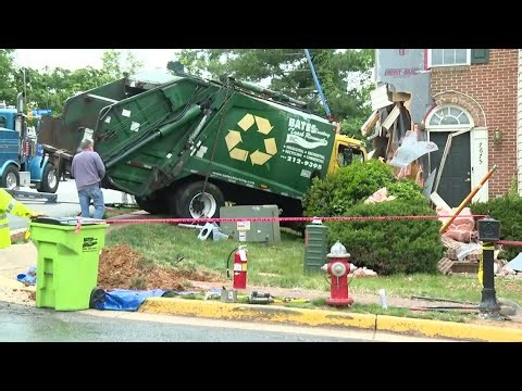 Garbage truck slams into a home, hitting a gas meter and an electrical line