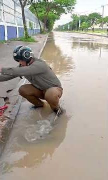 Clearing a Clogged Drain to Stop a Dangerous Street Flood