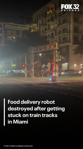 A food delivery robot was destroyed after getting stuck on train tracks in Miami. Video shows the robot motionless on the tracks before a train approached and struck it. | READ: bit.ly/4bbhogE | Fox 32 Chicago