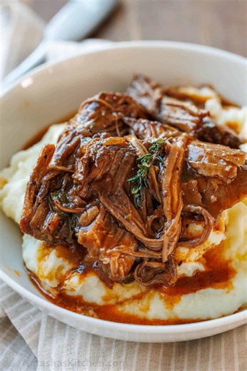 Our classic Pot Roast Recipe makes fall-apart tender beef in a rich sauce cooked slow in the oven. Recipe: https://natashaskitchen.com/pot-roast/ | NatashasKitchen.com