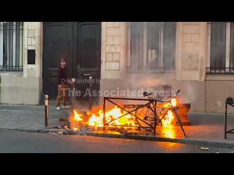 Fires set in Paris streets during protests, with businesses damaged and looting reported