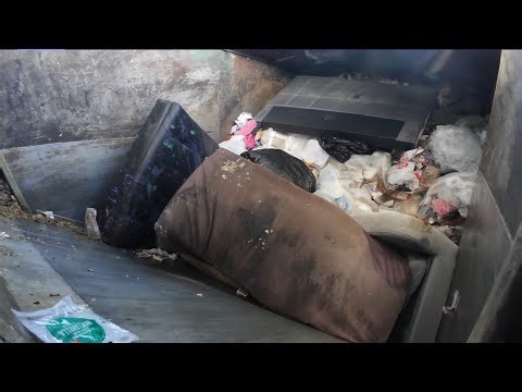How a Waste Management commercial front load garbage truck smashes garbage inside view